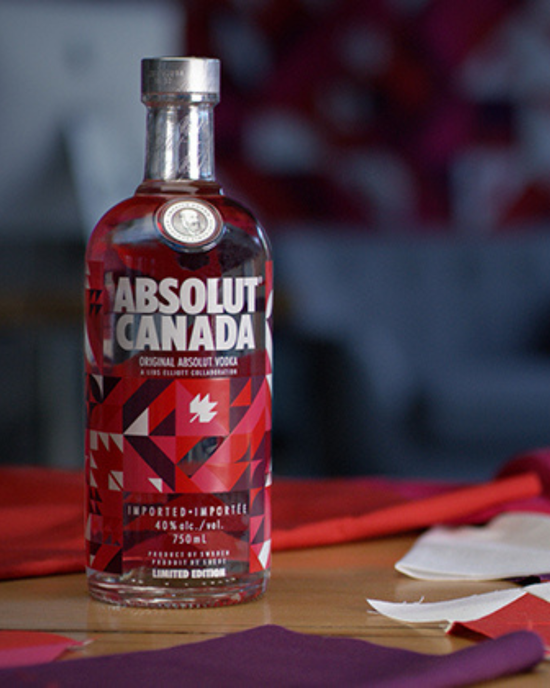 Bottle of Absolut Canada vodka on a table with a blurred background