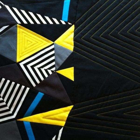 Close-up of a geometric pattern with triangles and lines on a dark background