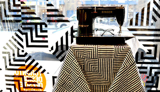 Sewing machine on a patterned tablecloth with abstract designs in the background
