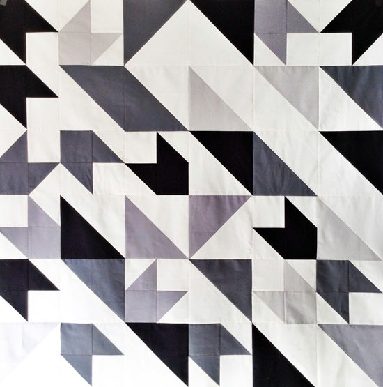 Geometric pattern with black, white, and gray triangles on a white background