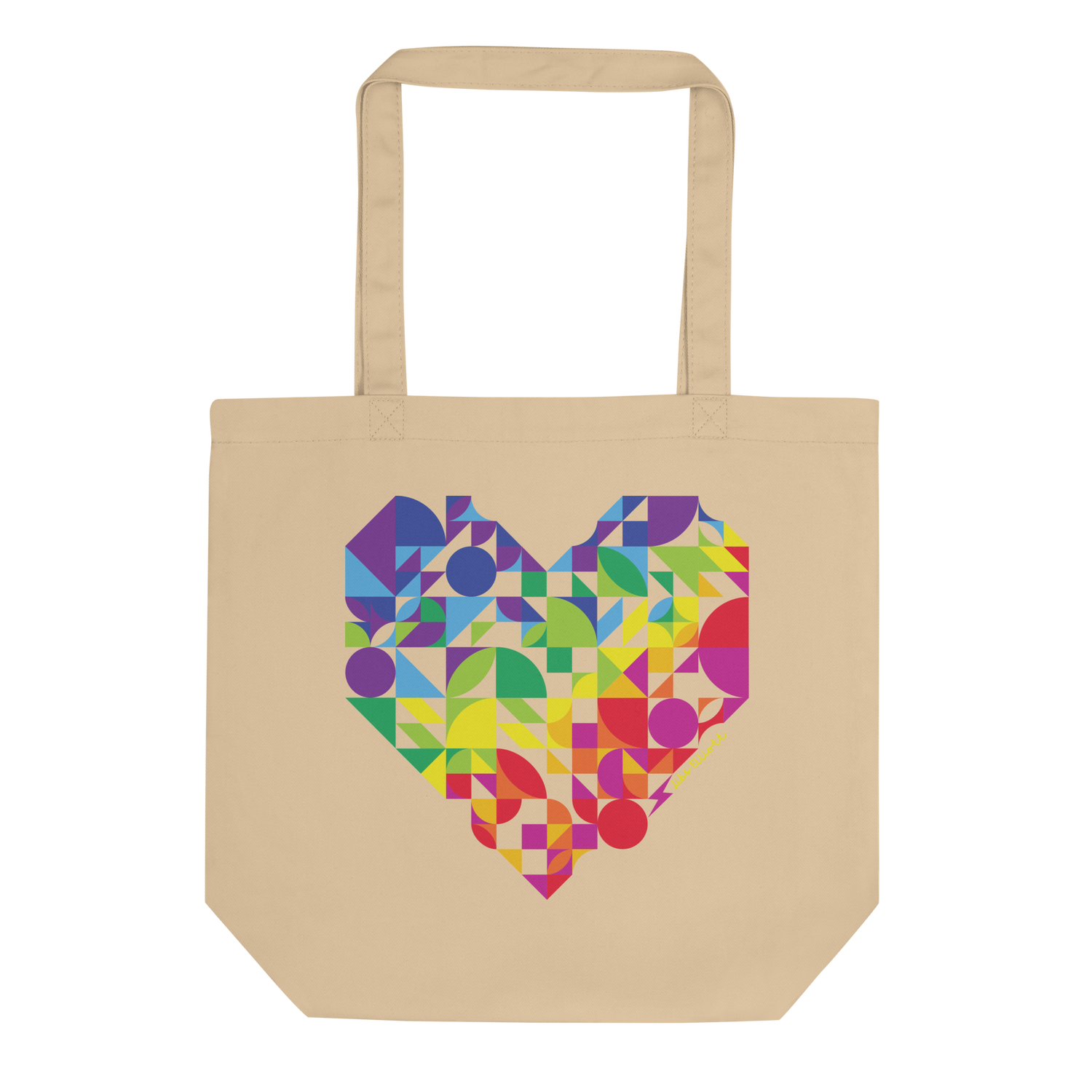 Beige tote bag with a colorful geometric heart design on a white background