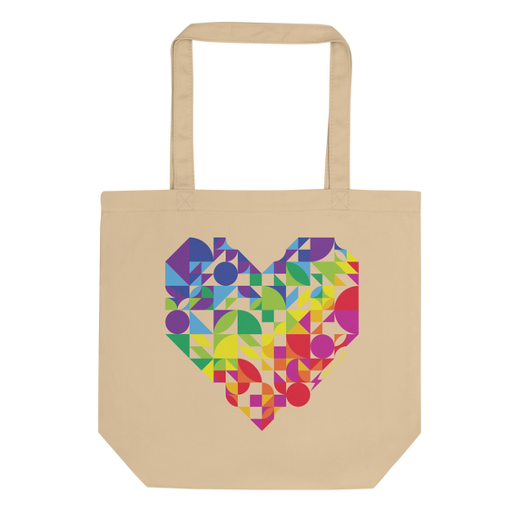 Beige tote bag with a colorful geometric heart design on a white background