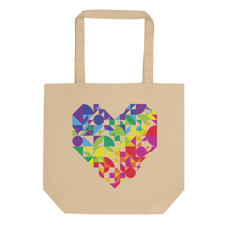 Beige tote bag with a colorful geometric heart design on a white background